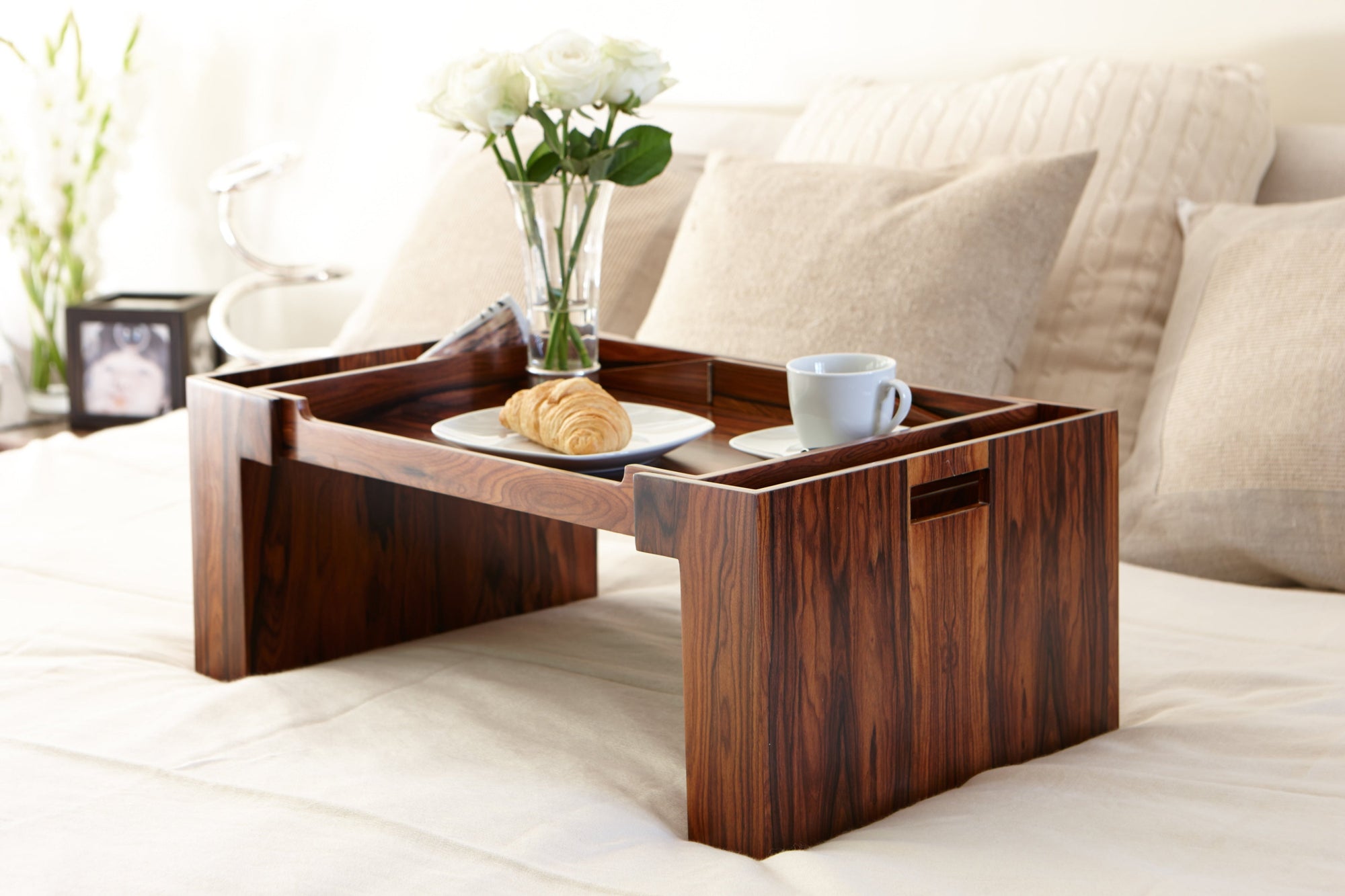 A bedroom that creates a space both lived-in and luxurious, from the tray to the frames, the pen box to the photo cubes. The wood adds a sense of timelessness,